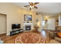 Cozy living room featuring a fireplace, high ceiling, and a round decorative rug at 4256 Zachary Ln, Westfield, IN 46062