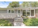 Inviting front entrance with a stone walkway, modern windows, and stylish exterior lighting at 4622 S Franklin Rd, Indianapolis, IN 46239