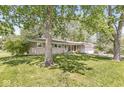 Beautiful single-story home with a well-manicured lawn and mature trees in the front yard at 4622 S Franklin Rd, Indianapolis, IN 46239