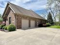 Large two-car garage and expansive driveway offer plenty of parking at 5200 W Shoreline Ter, Muncie, IN 47304