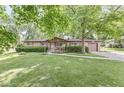 Charming brick ranch home featuring a well-manicured lawn and inviting curb appeal with a covered front entry at 5427 Heights Ave, Indianapolis, IN 46237