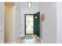 Inviting entryway features tile floors, a coat closet, and a view of the front yard through a glass door at 560 Old Farm Rd, Danville, IN 46122