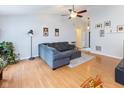 Comfortable living room with hardwood floors, a cozy gray sofa, and a ceiling fan at 560 Old Farm Rd, Danville, IN 46122
