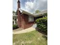 This brick home features steps and a walkway, with a classic chimney, offering a warm and inviting facade at 5960 Southeastern Ave, Indianapolis, IN 46203