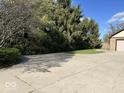 Long, spacious driveway leading to a well-maintained home with mature trees providing ample shade at 6143 Roberts Pl, Indianapolis, IN 46220