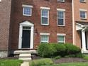 Attractive brick townhome with well-maintained landscaping and inviting front door at 6304 El Paso St, Whitestown, IN 46075