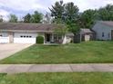 Charming single story home with a brick facade, attached garage, and a well-maintained lawn at 6723 S New Jersey St, Indianapolis, IN 46227