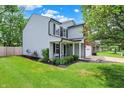 Two-story home with gray siding and well-manicured front yard at 6809 Amber Springs Way, Indianapolis, IN 46237