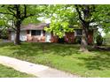 Charming single-story home with attached garage and manicured lawn at 706 Bobs Ct, Beech Grove, IN 46107
