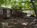 Welcoming brick home featuring a covered carport and a neatly kept front yard at 7141 E 48Th St, Indianapolis, IN 46226