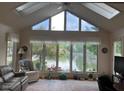 Bright sunroom with large windows offering serene lake views, creating a peaceful retreat at 7440 Sylvan Ridge Rd, Indianapolis, IN 46240