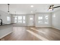 Open-concept living room with hardwood floors and a view of the kitchen island and bright windows at 786 James William Ln, Westfield, IN 46074
