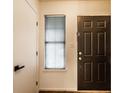 Clean entryway featuring a front door with a window and adjacent coat closet, illuminated by natural light at 9118 Hardwood Ct, Indianapolis, IN 46250
