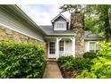 Inviting front porch with stone accents and decorative columns, leading to a charming entryway at 9118 Hardwood Ct, Indianapolis, IN 46250