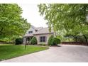 Spacious property with a long driveway, well-kept lawn, and mature trees offering shade at 9127 Pointe Ct, Fishers, IN 46037
