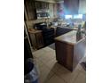 Functional kitchen with tile flooring, wood cabinets, and modern black appliances at 9210 Brantford Ct, Indianapolis, IN 46260