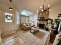 Inviting living room featuring a stone fireplace, vaulted ceilings, and ample natural light at 9277 Embers Way, Indianapolis, IN 46250