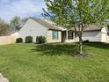 Well-maintained home showcasing a lush green lawn and mature shade tree at 948 Kitner Ave, Avon, IN 46123