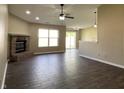 Open living room featuring a brick fireplace, ceiling fan, and sliding glass doors at 948 Kitner Ave, Avon, IN 46123