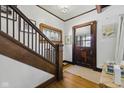 Warm entryway featuring hardwood floors, an original front door, and a stained glass window accent at 1132 Evison St, Indianapolis, IN 46203