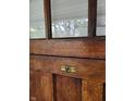 Close up of the wooden front door, showing a detailed brass peephole, and design at 1132 Evison St, Indianapolis, IN 46203