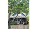 Charming blue two-story home with brick accents, a covered porch, and a white picket fence at 1132 Evison St, Indianapolis, IN 46203