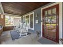 Inviting front porch with rocking chairs, a blue rug, and craftsman architectural details at 1132 Evison St, Indianapolis, IN 46203