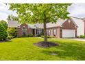 Beautiful brick home with lush green lawn and mature tree providing ample shade at 11419 Niagara Dr, Fishers, IN 46037