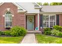 Charming front porch with a decorative wreath on the door and lovely landscaping at 11419 Niagara Dr, Fishers, IN 46037
