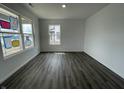 Bright and spacious living room featuring vinyl floors and large windows at 1204 Mcbride St, Greenfield, IN 46140
