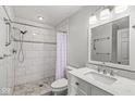 Bright bathroom features a walk-in shower, and vanity with solid surface counter and undermount sink at 12388 Camberley Ln, Carmel, IN 46033