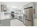Modern kitchen boasts stainless steel appliances, light blue cabinetry, and bright countertops at 12388 Camberley Ln, Carmel, IN 46033
