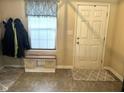 Welcoming entryway featuring a storage bench, neutral decor, and a practical space for coats and shoes at 160 Rambling Rd, Greenfield, IN 46140