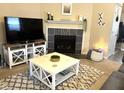 Cozy living room showcasing a fireplace, decorative mantel, and comfortable seating arrangement at 160 Rambling Rd, Greenfield, IN 46140