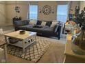 Spacious living room with a large sectional sofa, stylish coffee table, and bright natural light at 160 Rambling Rd, Greenfield, IN 46140