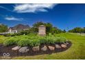 Inviting community entrance with manicured landscaping, and decorative signage at 1701 Summerwood Blvd, Greenfield, IN 46140