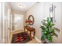 Welcoming foyer with neutral walls, an antique table, and a decorative area rug at 1701 Summerwood Blvd, Greenfield, IN 46140