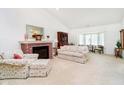 Inviting living room with vaulted ceiling, fireplace, and large windows for natural light at 194 Waterford Ct, Avon, IN 46123