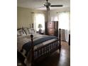 Comfortable bedroom with a wood-frame bed, matching dresser, and natural light filtering through sheer curtains at 21749 Oak Ridge Rd, Sheridan, IN 46069