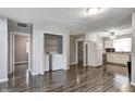 Kitchen with an open layout featuring white cabinets, laminate flooring, and modern appliances at 2228 Dover St, Anderson, IN 46013