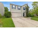 Charming two-story home with a well-maintained lawn, two-car garage and beautiful blue shutters at 2249 Blossom Dr, Greenwood, IN 46143
