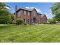 Charming two-story brick home with blue shutters and a well-manicured lawn at 248 Runyon Ct, Greenwood, IN 46142