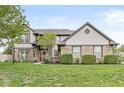 Beautiful two-story home with a well-manicured lawn and tasteful landscaping adding to its curb appeal at 2802 Singletree Dr, Indianapolis, IN 46234