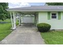 Attached carport provides covered parking and access to the detached garage at 2840 W 12Th St, Anderson, IN 46011