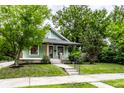 Attractive bungalow with a tidy front yard and welcoming entrance at 309 N Riley Ave, Indianapolis, IN 46201