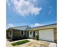 Attractive ranch-style home features stone accents, a garage, and a well-maintained lawn at 3414 Rost Dr, Columbus, IN 47203