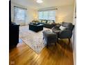Comfortable living room area with wood floors, area rug, and neutral colors with modern furnishings at 3414 Rost Dr, Columbus, IN 47203