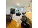 Bright living room featuring wood floors, neutral walls, an area rug, and comfortable seating at 3414 Rost Dr, Columbus, IN 47203