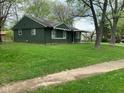 Side view of a single-story home with a well-manicured lawn and mature trees at 3742 N Wittfield St, Indianapolis, IN 46235