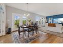 Open dining area with hardwood floors, area rug, and a view to the living room at 3948 Saddle Club S Pkwy, Bargersville, IN 46106